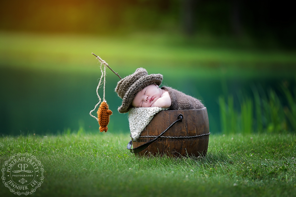 newborn boy outside fishing bucket web