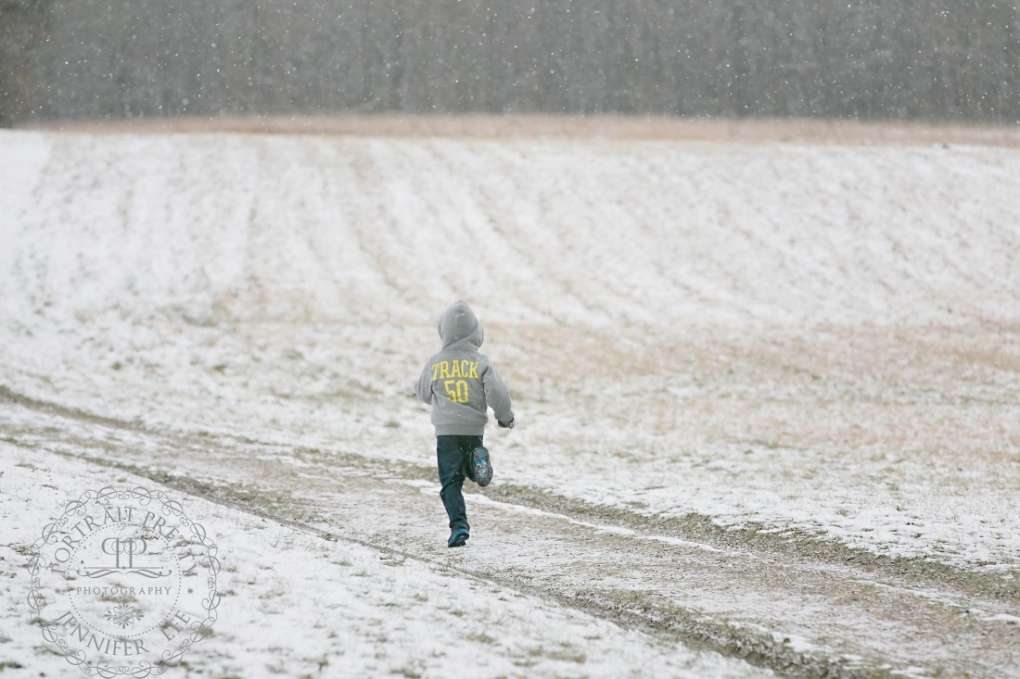 boy running snow portrait