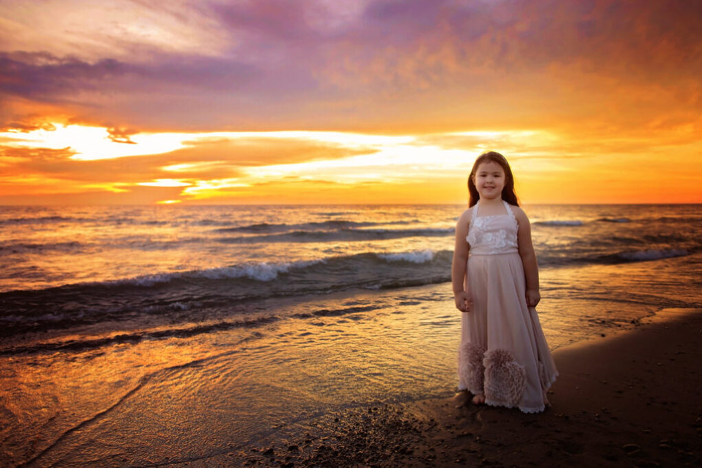 beautiful portrait of little girl at sunset at buffalo ny beach lake erie beach photographer. looks like the ocean.  gorgeous sunset portrait