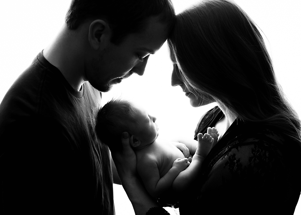 newborn portrait with parents backlight